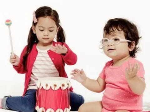 a couple of girls holding a toy