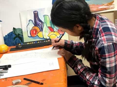 a person painting on a white board