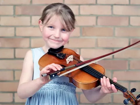 a girl playing a violin