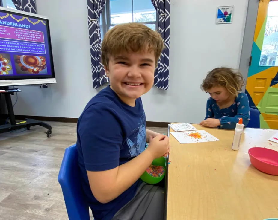 a boy sitting at a table