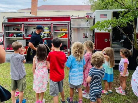 a group of children standing in front of a food truck