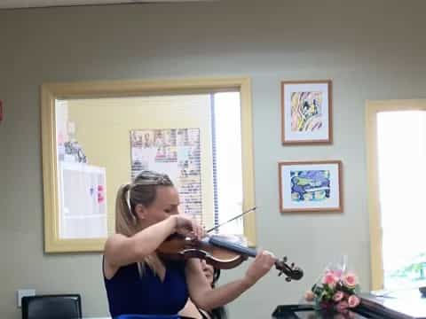 a woman playing a violin