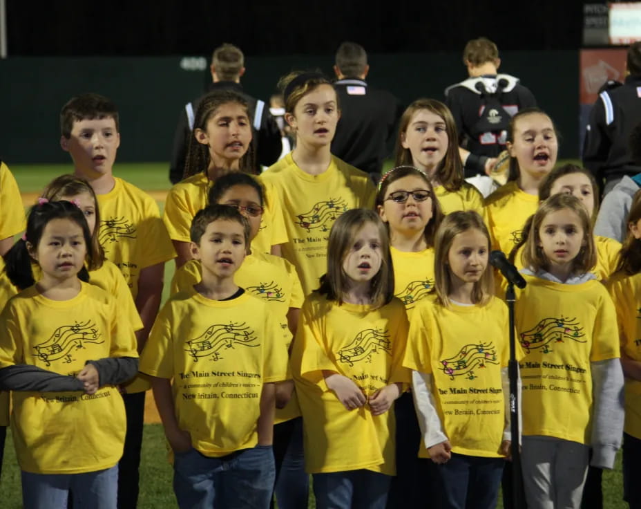 a group of people wearing yellow shirts