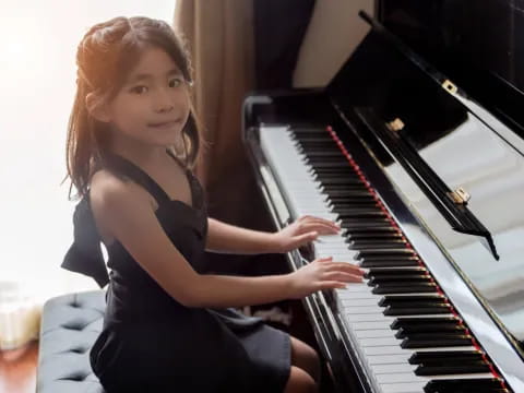 a girl playing a piano