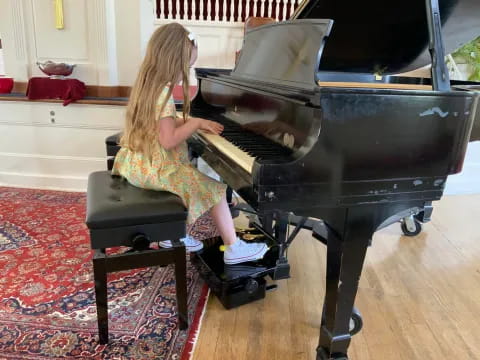 a girl playing a piano