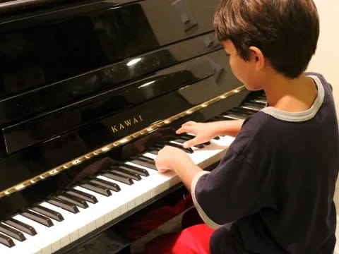 a boy playing a piano