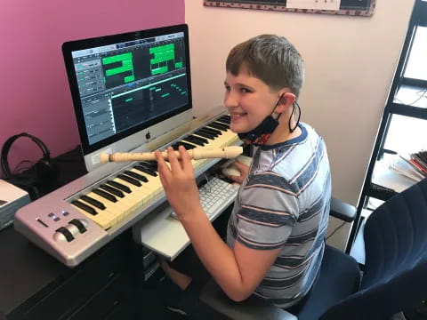 a boy playing a piano