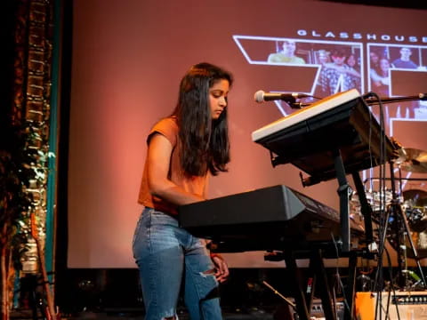 a person standing in front of a piano