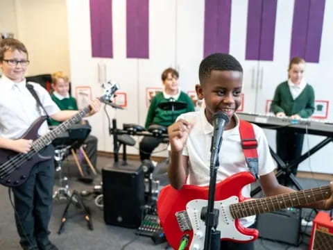 a group of boys playing guitars