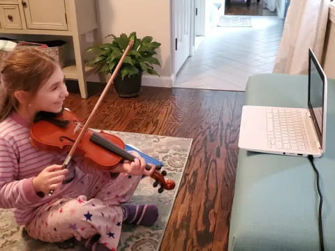 a girl playing a violin