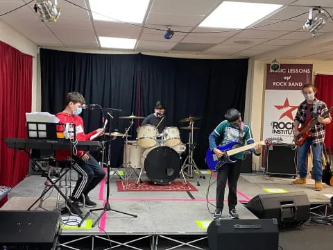 a group of people playing instruments on a stage