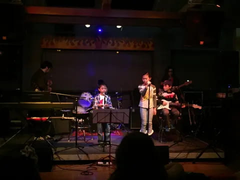 a group of people playing instruments on a stage