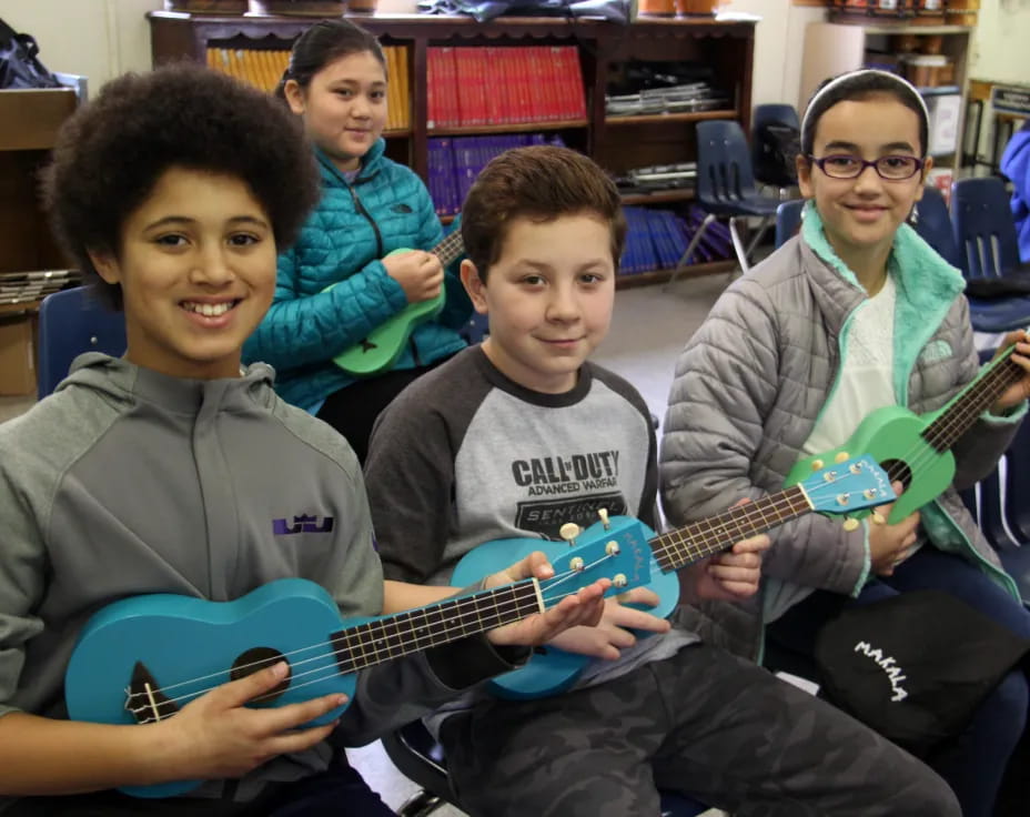 a group of kids holding guitars