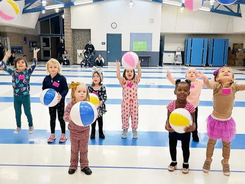 a group of children holding balloons