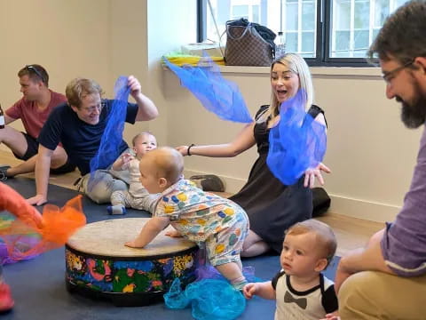 a group of people playing with baby toys