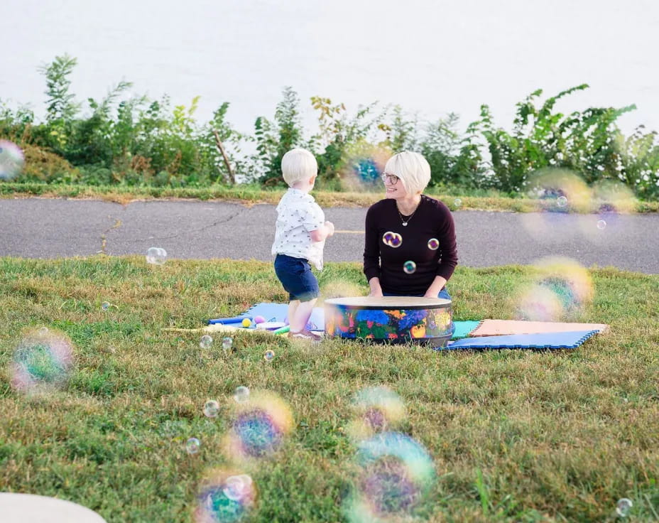 a person and a child playing on a picnic table