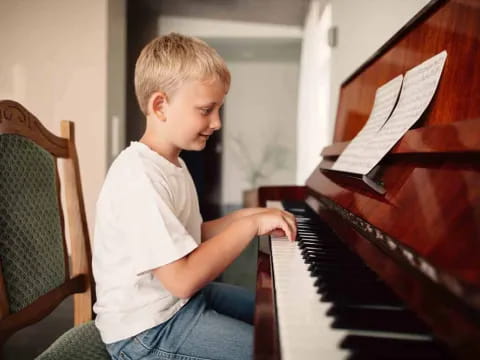 a boy playing a piano