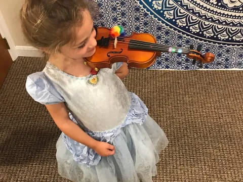 a baby playing a violin