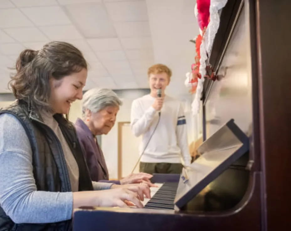 a group of people looking at a laptop