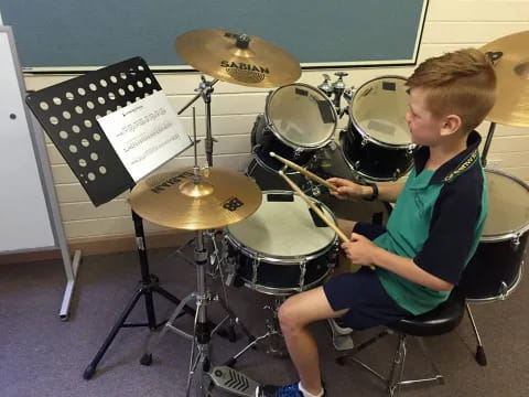 a boy playing the drums