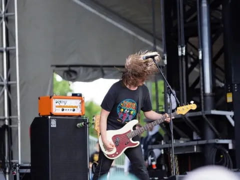 a man playing a guitar on a stage