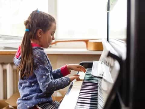 a girl playing a piano