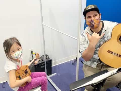 a person and a girl playing guitars