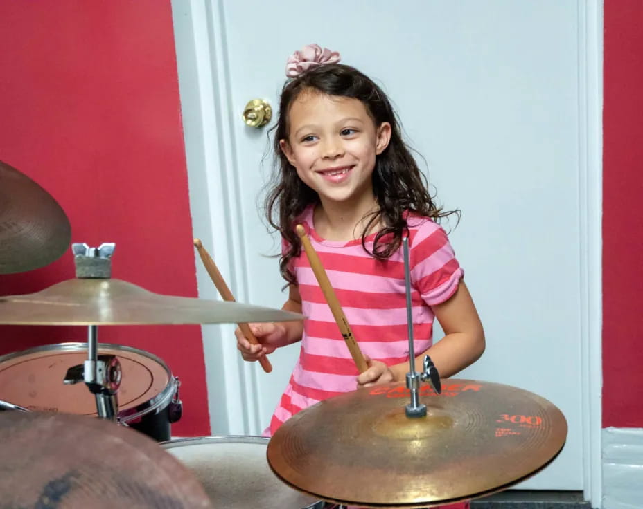 a girl playing drums