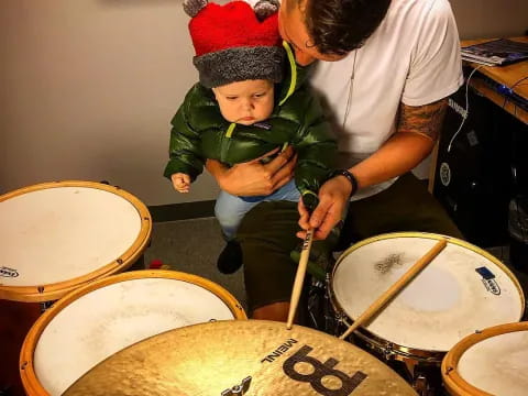 a person and a child playing drums