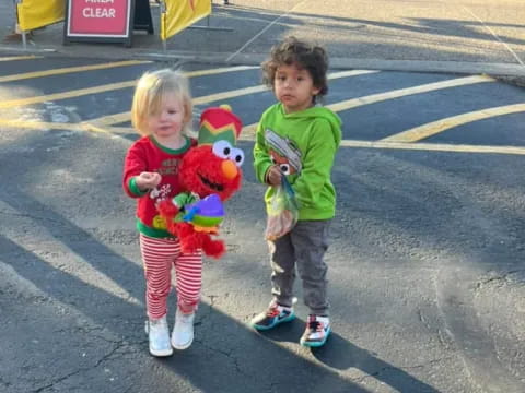 two children holding stuffed animals
