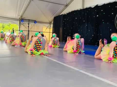 a group of women in colorful dresses