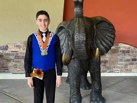 a person standing next to a statue