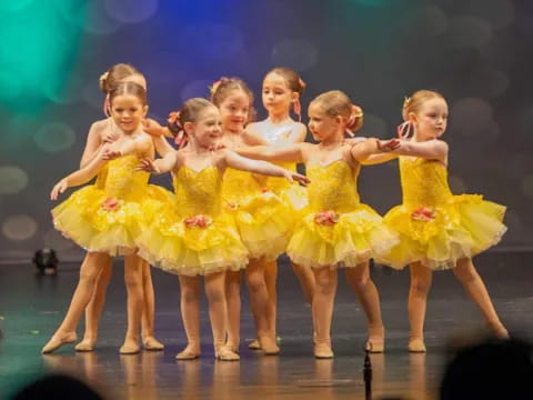 a group of girls in yellow dresses