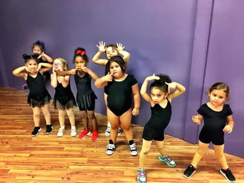 a group of girls in black and white uniforms on a stage