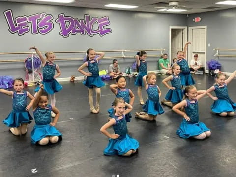 a group of children in blue dresses