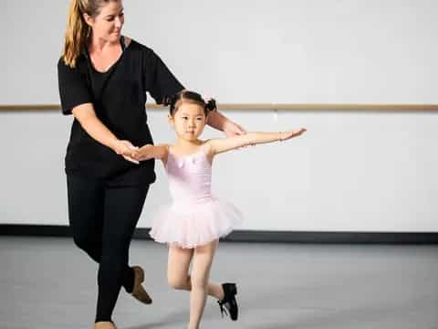 a woman and a girl dancing