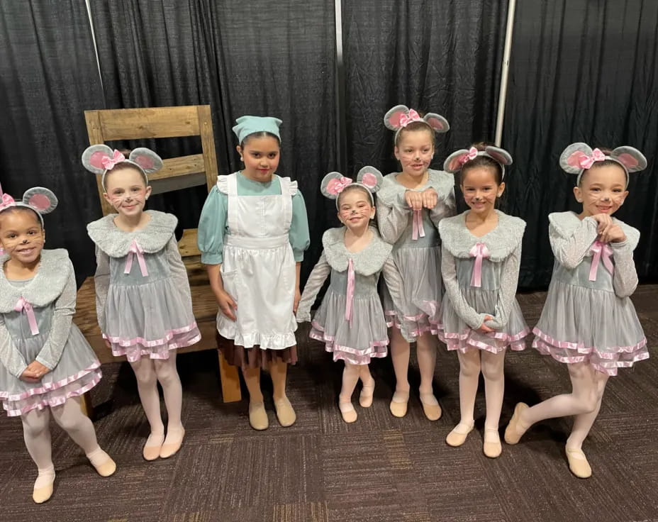 a group of girls in dresses