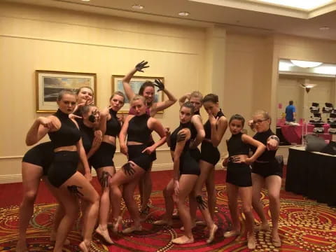 a group of women in black dancing