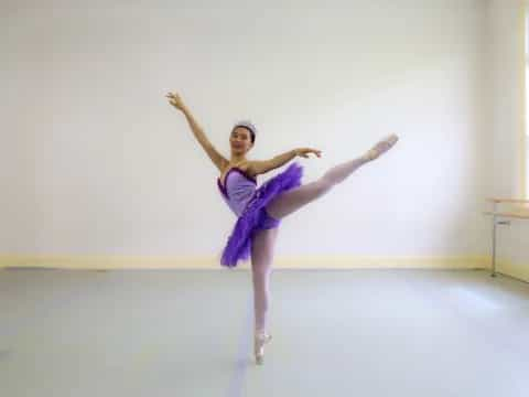 a person in a purple dress dancing