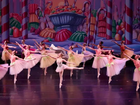 a group of dancers performing on a stage