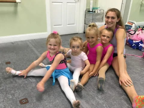 a group of girls sitting on the floor