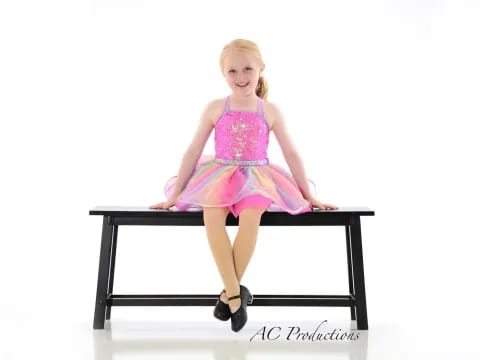 a person in a dress sitting on a table