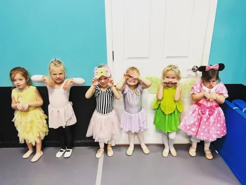 a group of girls in dresses