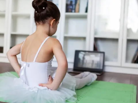 a person sitting on a yoga mat