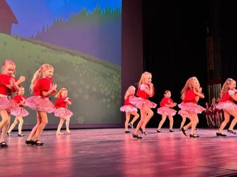 a group of girls dancing on a stage