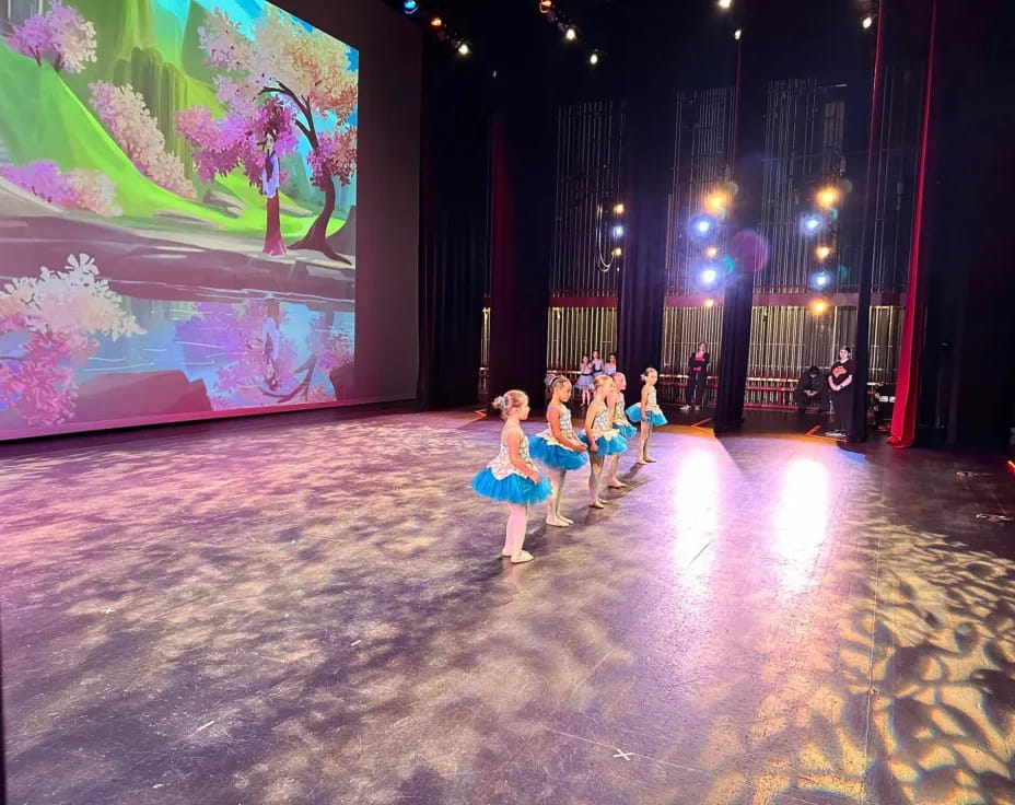 a group of people dancing on a stage