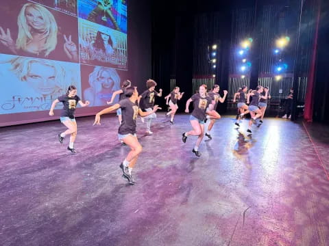 a group of people dancing on a stage