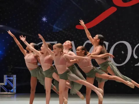 a group of people dancing on a stage