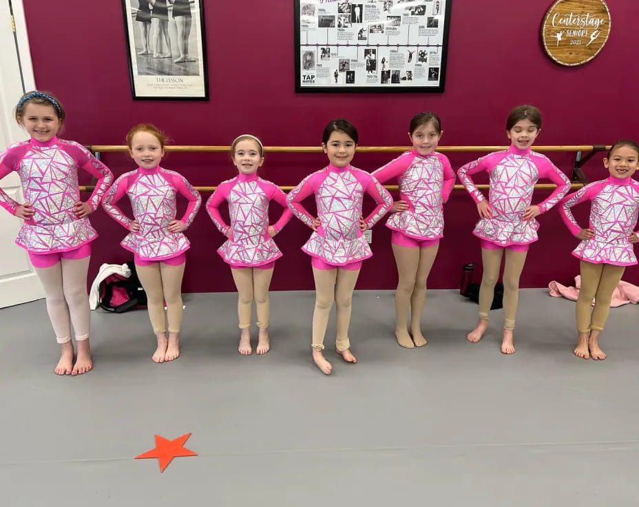 a group of girls in matching outfits