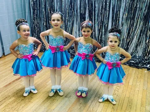 a group of girls in dresses